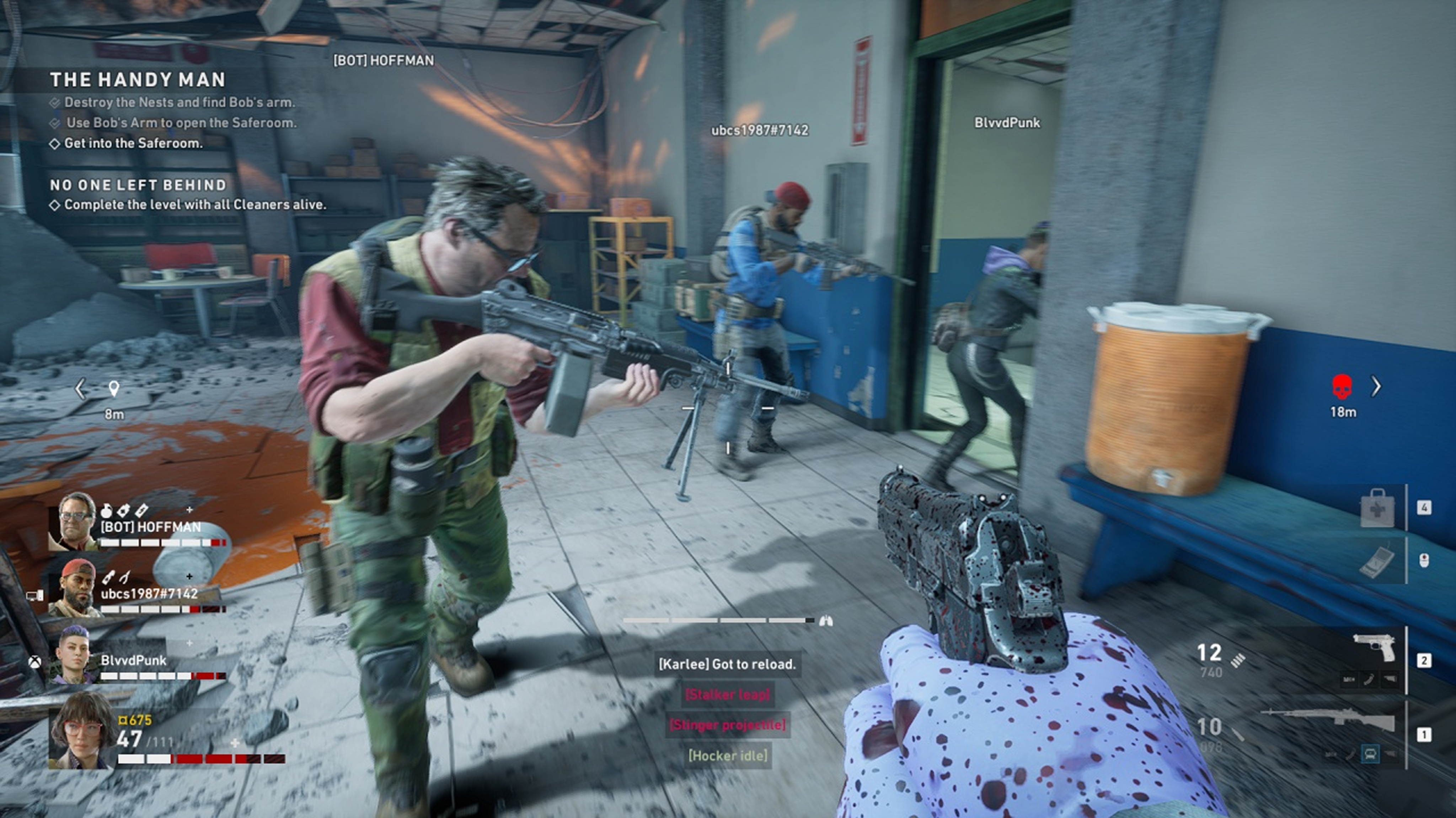 Another screenshot, this time showing a multiplayer session. The player is aiming at one of their colleagues. The player can see two other colleagues going inside a room. The area looks like the indoor area of a building. The walls are white with blue stripes in the bottom part. There are many game HUD elements on screen, showing the current health of all players and the weapons equipped by the player, a rifle and a handgun. Some objectives are displayed on the top left of the screen..